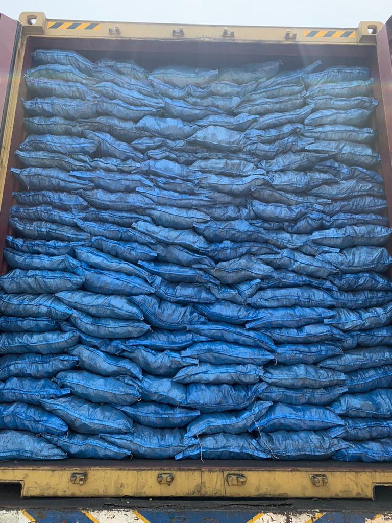 Stacked Akira Charcoal pallets being loaded for UK shipment at Lagos port.